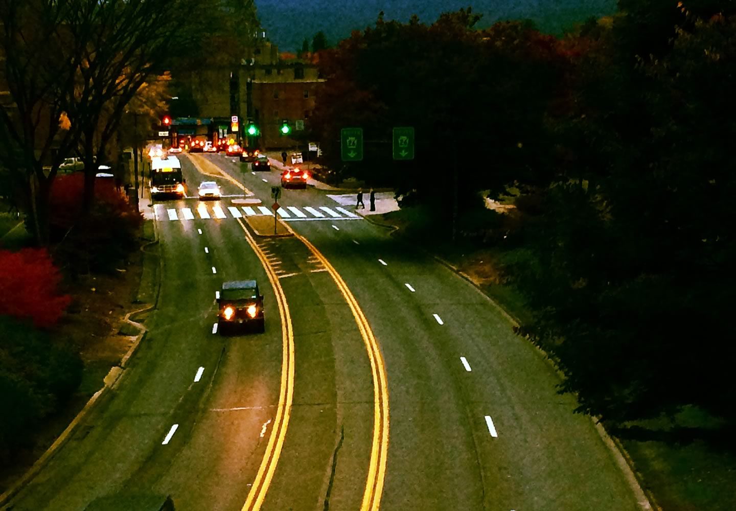 A wide angle shot of traffic at night in downtown State College