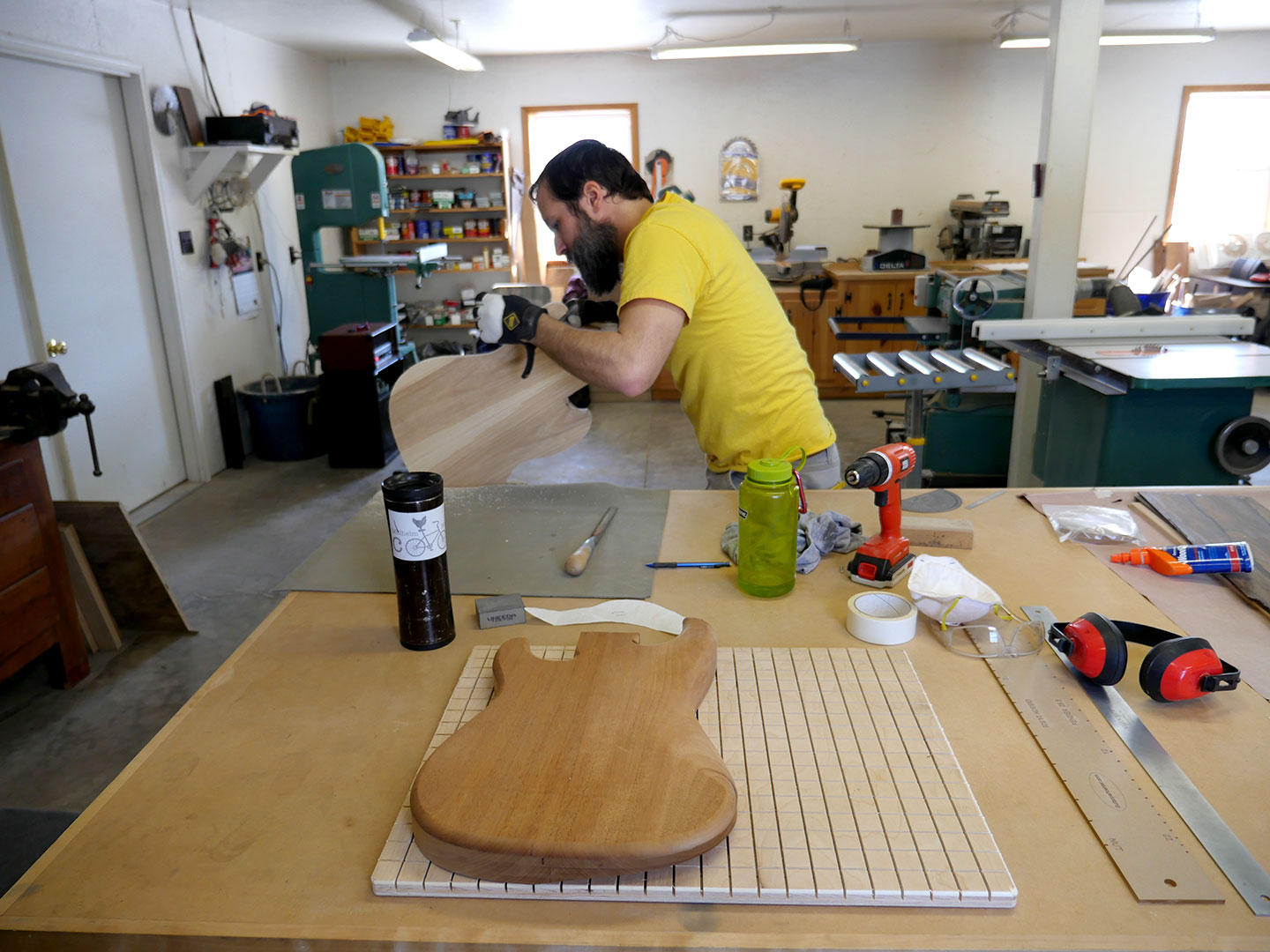Gary Long shapes a guitar body in his luthiery workshop